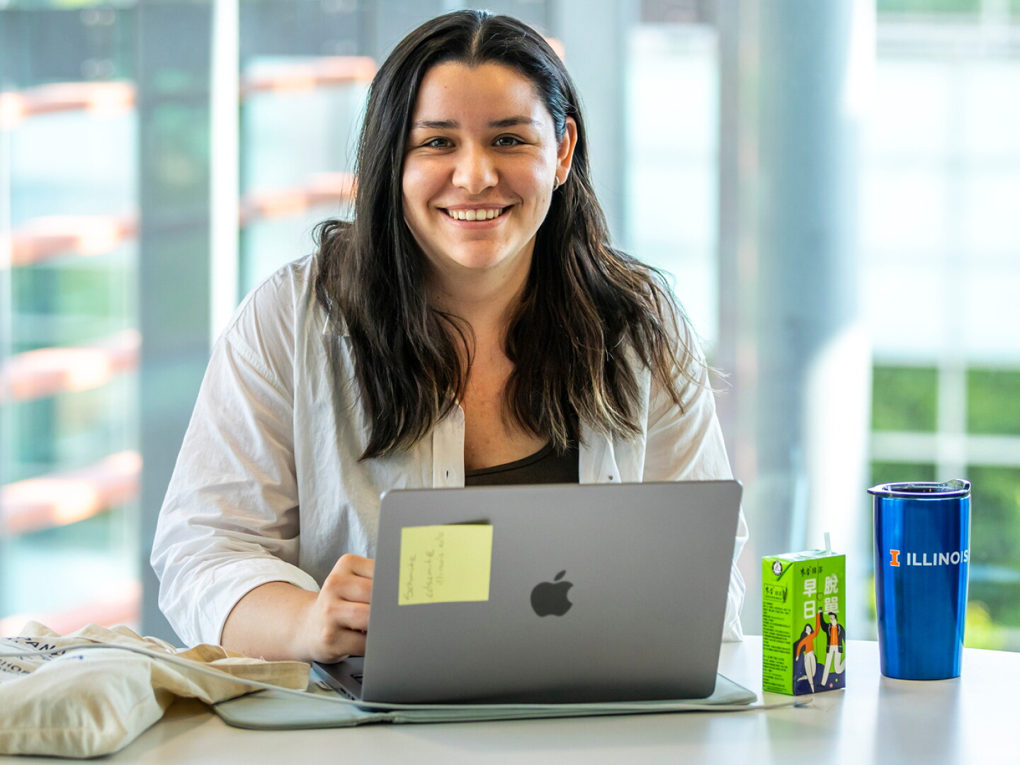 Smiling student working working on her laptop