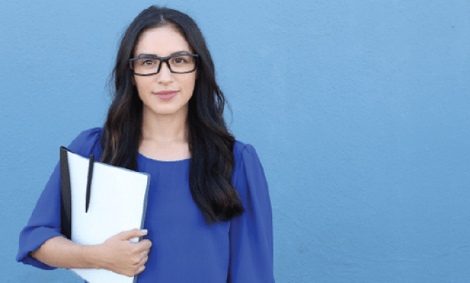 Woman with brown hair wearing glasses holding folder