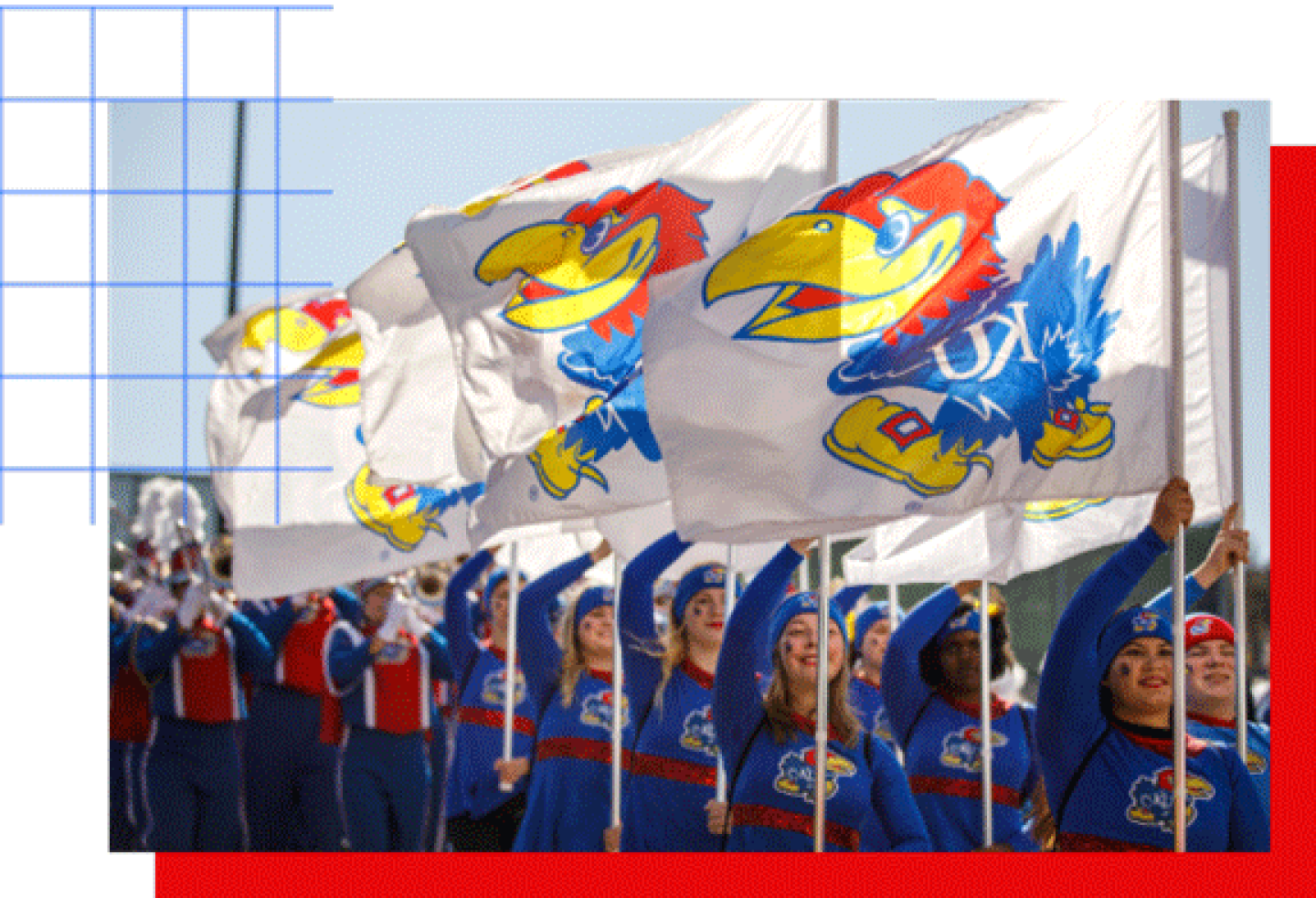 Kansas Jayhawks spirit squad marching outdoors, holding KU flags while a band performs behind them.