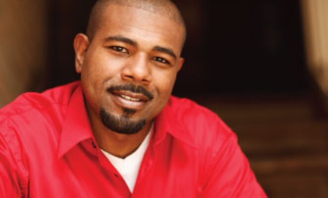 headshot african american man in red sweater