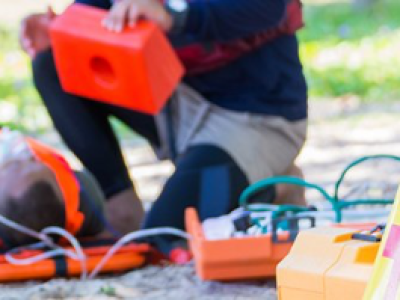 paramedic helping an injured person on the street