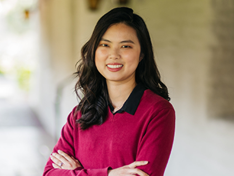 Smiling woman wearing a red sweatshirt