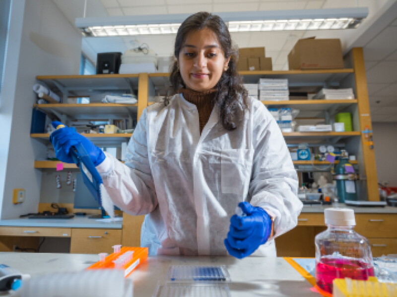 A female CWRU biomedical engineering student drawing a test sample in the campus lab.