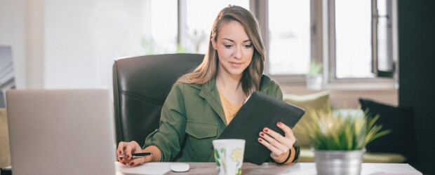 woman-using-tablet-and-laptop-with-real-estate-investment-software