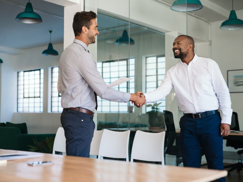 Two corporate men shaking hands