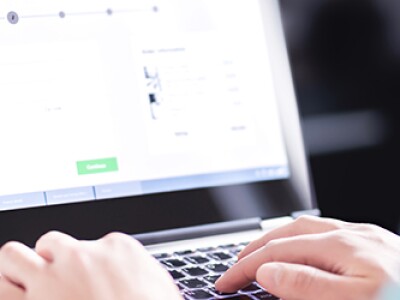 Person works on an online application portal on a laptop