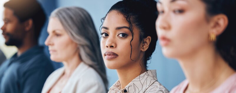 Business woman looking serious and sitting in a conference or workshop