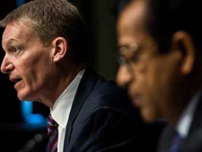 Two men at table one in focus and distressed