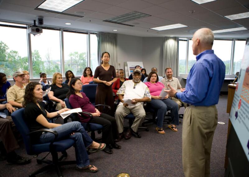 Diverse audience listening to speaking a meeting room