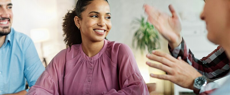 Female educator engaged in a lively discussion with colleagues