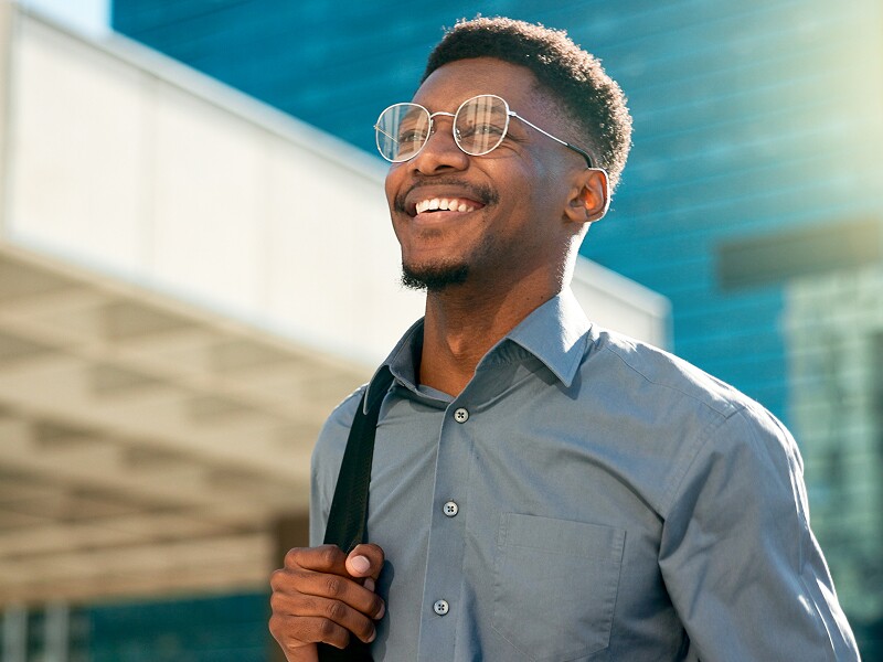 Smiling man walking on his morning commute to the office