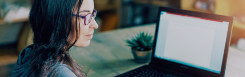 brunette-woman-at-laptop-in-glasses-succulent-next-to-computer