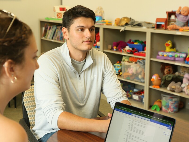 Two school counseling student in a classroom