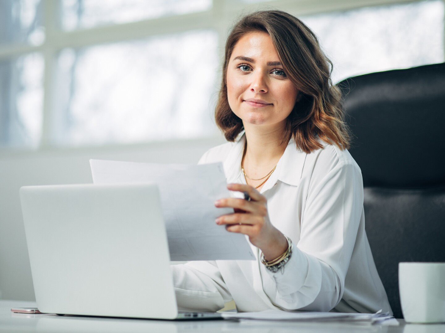 Female attorney working at her laptop in her office
