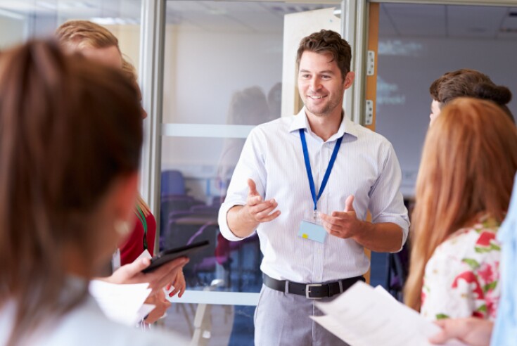 Teacher speaking with students