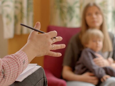 A counselor talking to a parent and child.