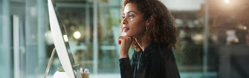 Thoughtful accountant working on her computer