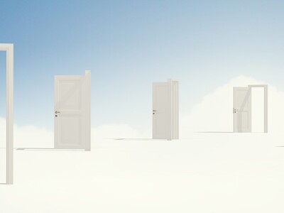 Man looking at open doors in dreamy cloud setting.