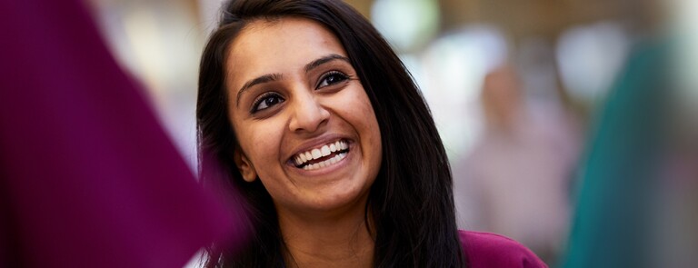Woman of color front facing and smiling