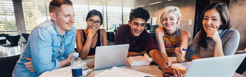 University students in cooperation with their online learning assignment.