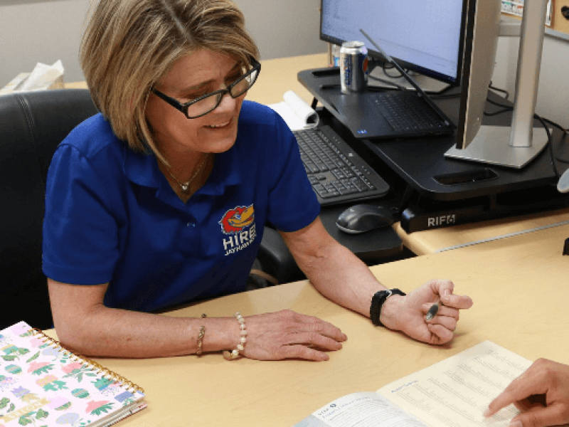 University of Kansas Beyond KU counselor assisting student in office