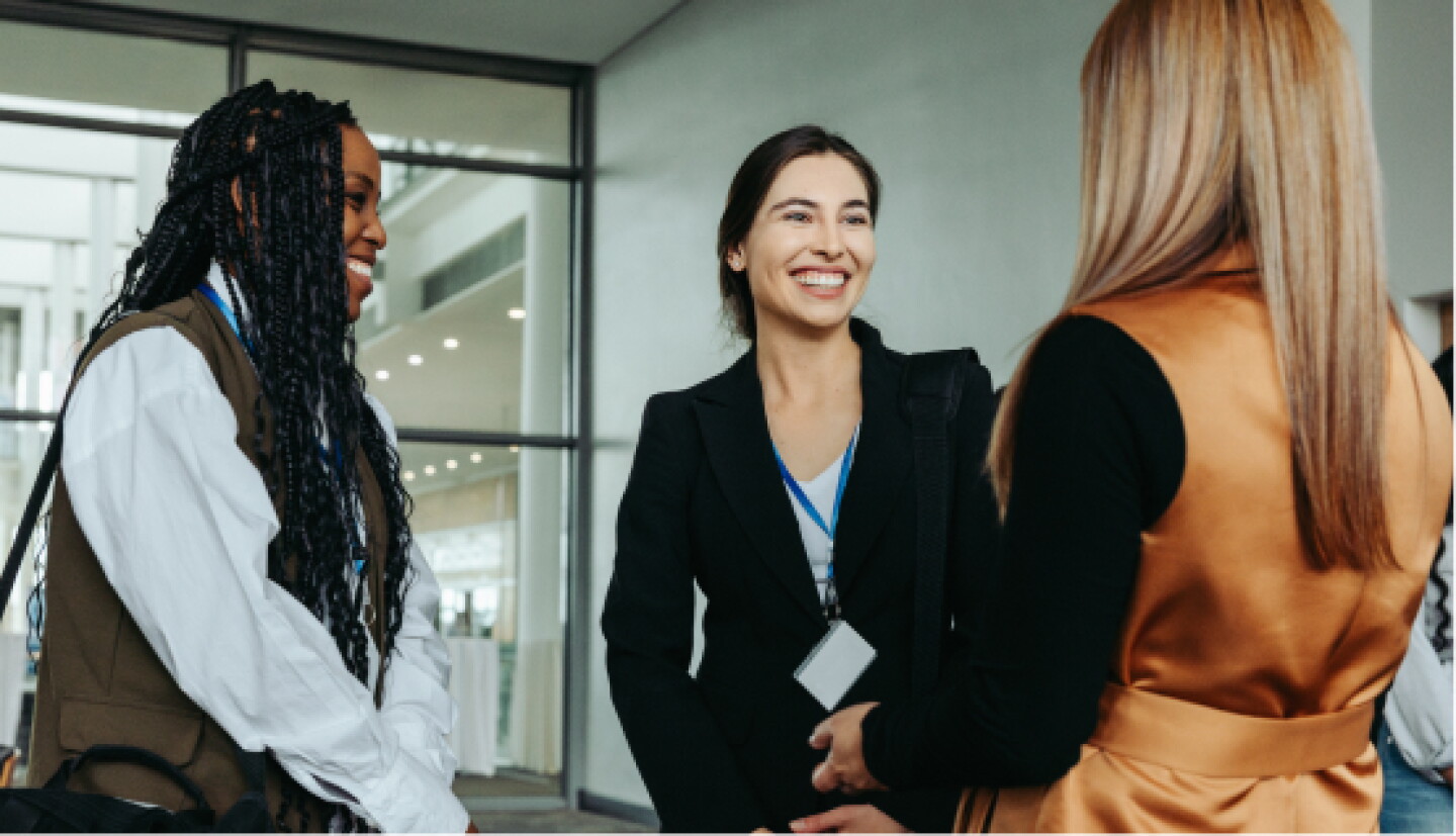A close-up of a female CWRU student conversing with colleagues at a meet and greet event.