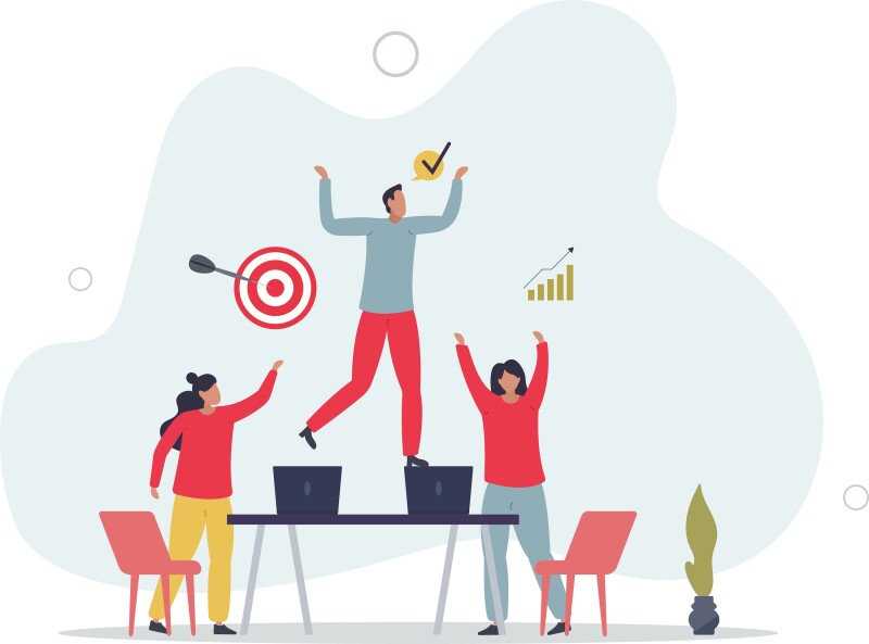 A group of people standing next to a table with computers