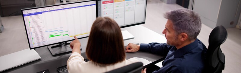 Two colleagues viewing an analytics dashboard 