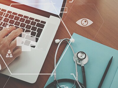 top view of nurse working with stethoscope and laptop