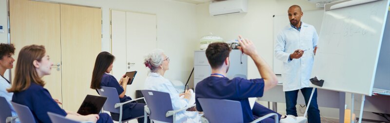 Medical team attending a training session in modern hospital setting.