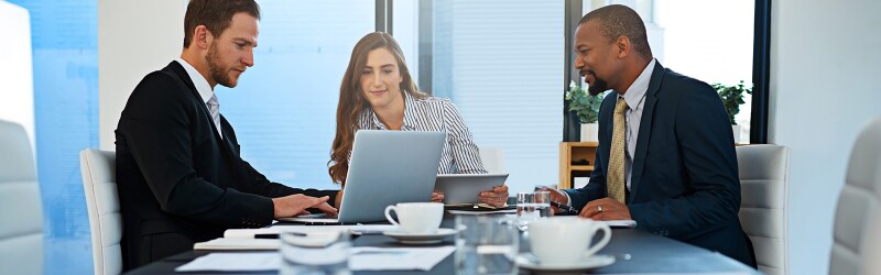 a diverse group of modern professionals discussing legal and technology issues in an office