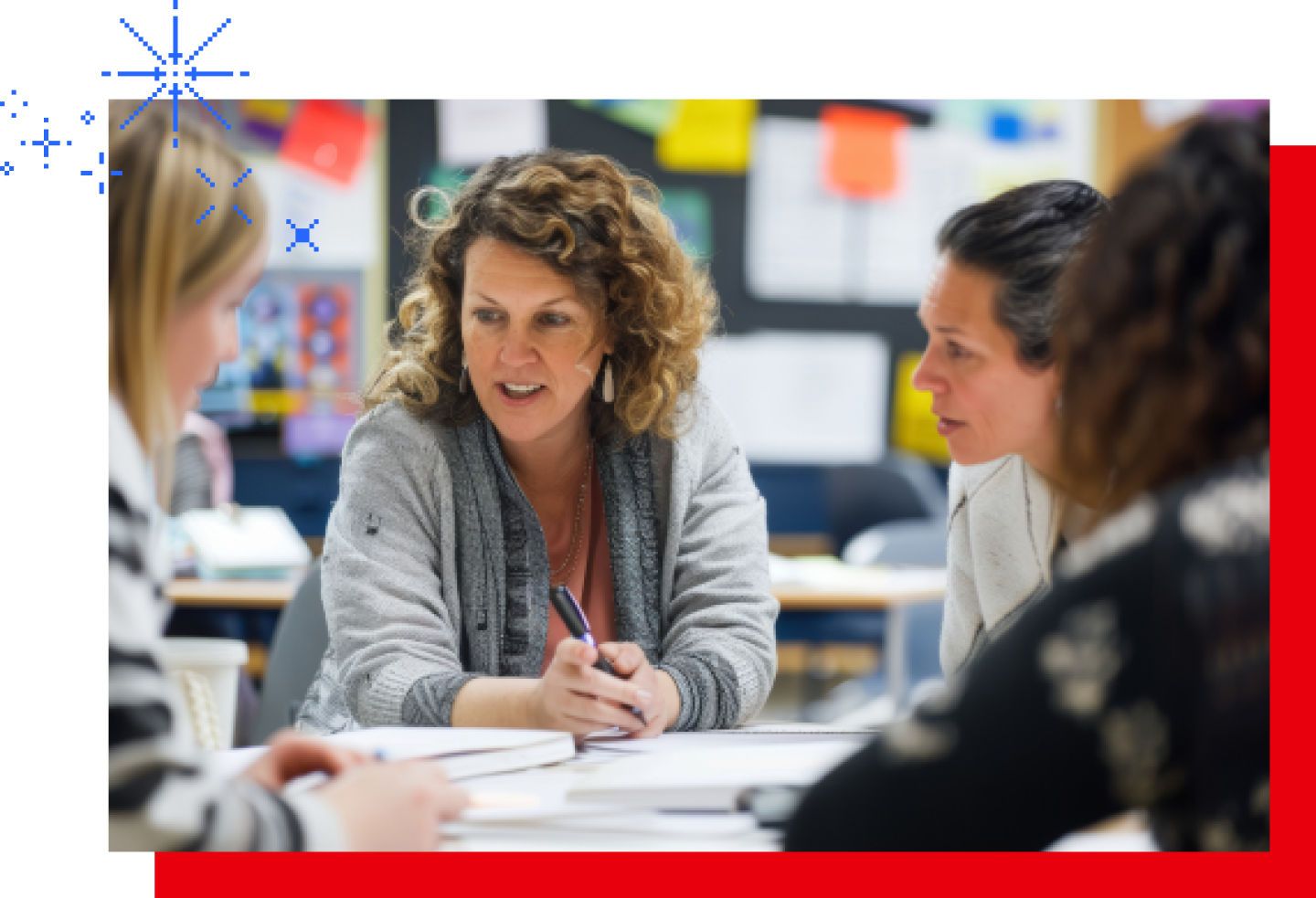 A female teacher is chatting with colleagues in the teacher's lounge.