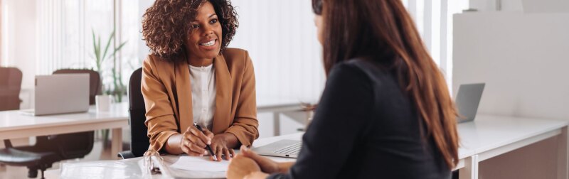 Woman consulting with a female financial manager at the bank.