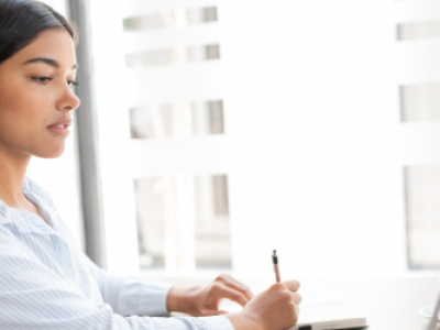 Professional woman working on laptop at her desk