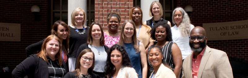 Students attending Tulane Law's Immersion Weekend events pause for a group photo in front the a building.