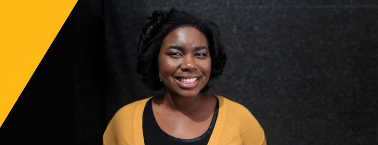 Smiling woman wears a yellow cardigan