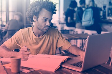 African American man studying at computer