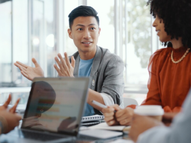A male business professional with colleagues.