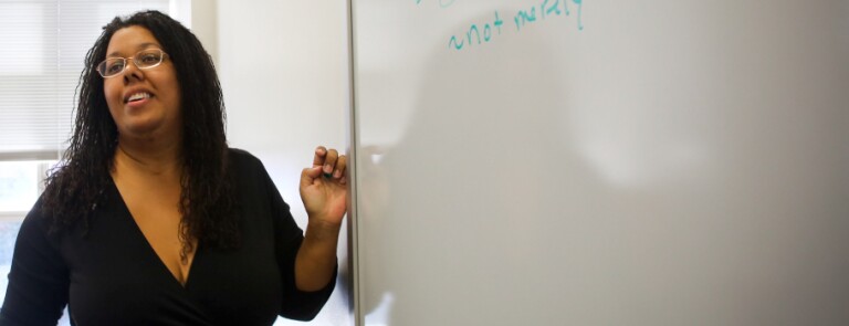 Professor Saru Matambanadzo stands at the whiteboard