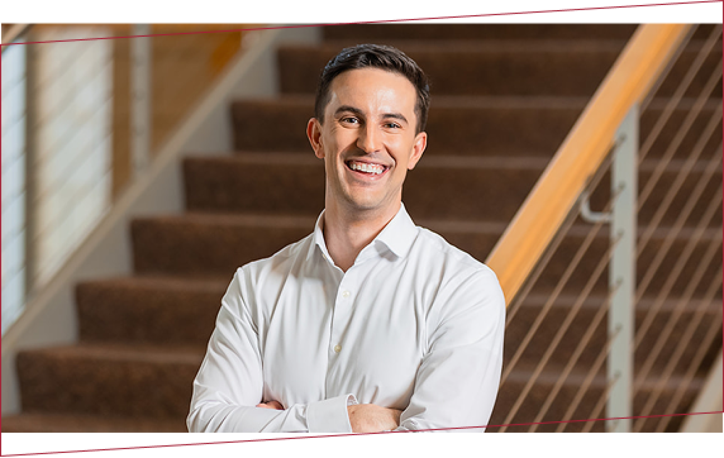 man standing at the end of a staircase with crossed arms