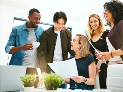 Diverse, cheerful and successful meeting with business people working, planning or brainstorming ideas strategy for project report or paper work.