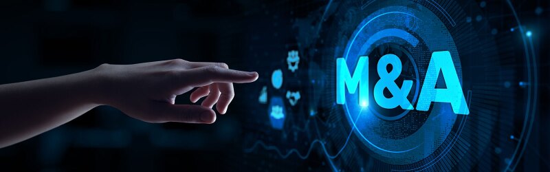 A hand pointing toward a digital display reading "M&A"