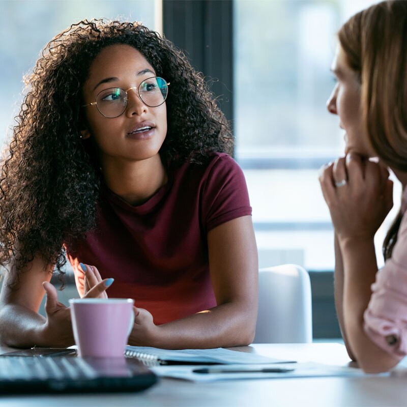 two women in conversation over coffee