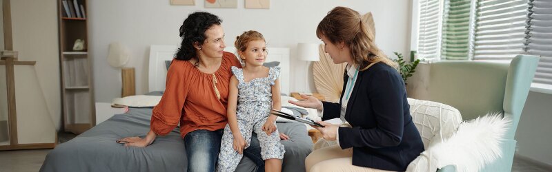 A parent and child interacting with a counselor