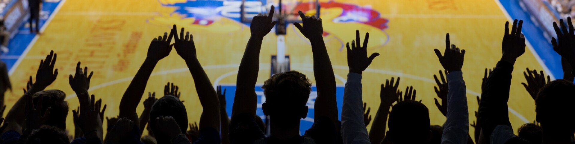 Audience cheering around KU basketball court