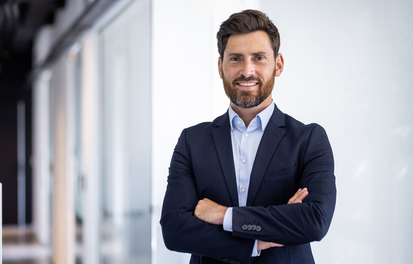 Male businessman standing in the office in a suit