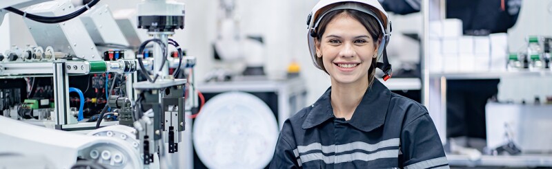 Female mechanical engineer with robotic welder