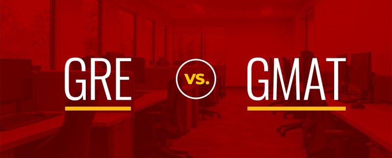 Stacked wooden blocks spelling out gre vs gmat.