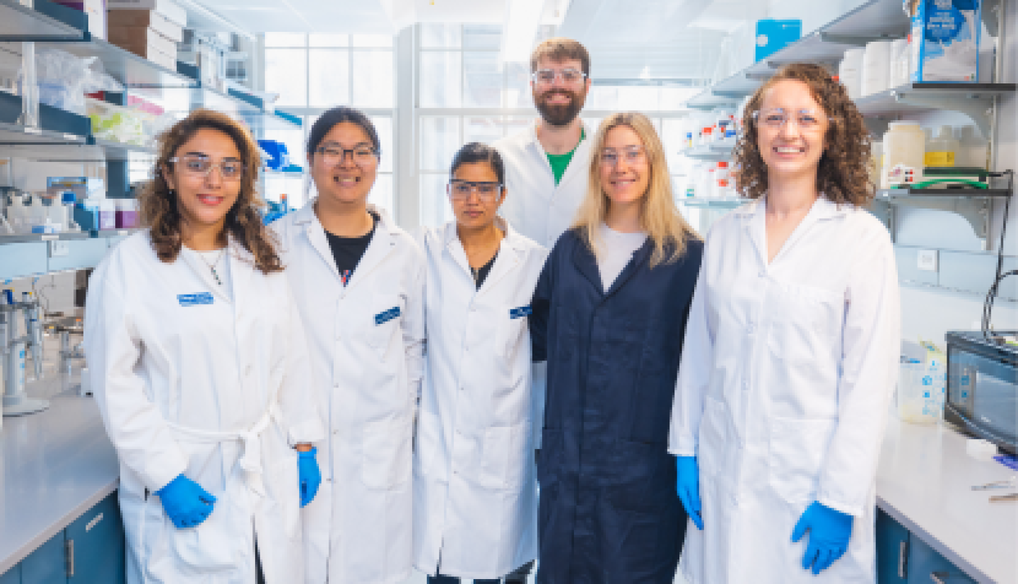A group of CWRU biomedical engineering students smiling in lab.