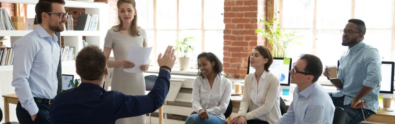 Team leader addressing a coworkers question during an office meeting.